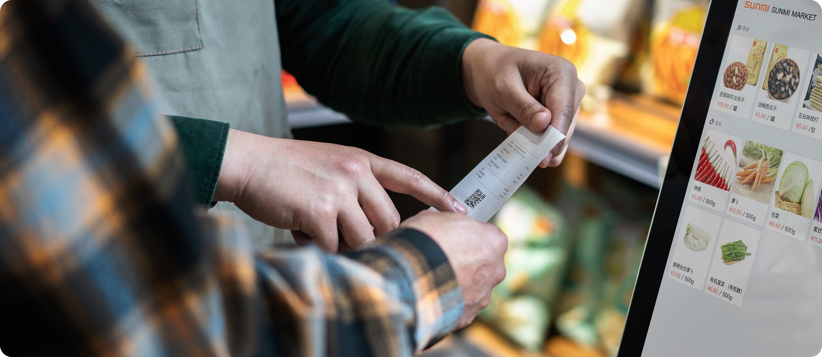 Staff handing a printed receipt from the Sunmi K2 Mini's built-in printer beside its menu screen